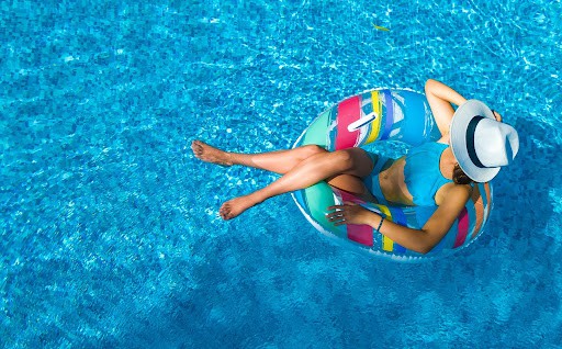 woman enjoys her pool kept clean with pool maintenance