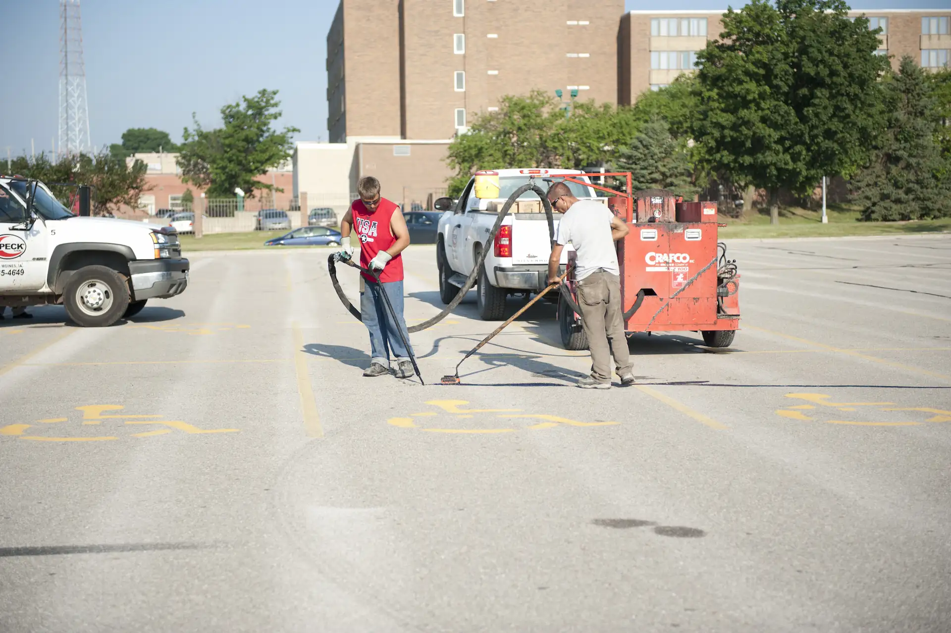 A parking lot service crew from Speck USA stripes a Des Moines parking lot.